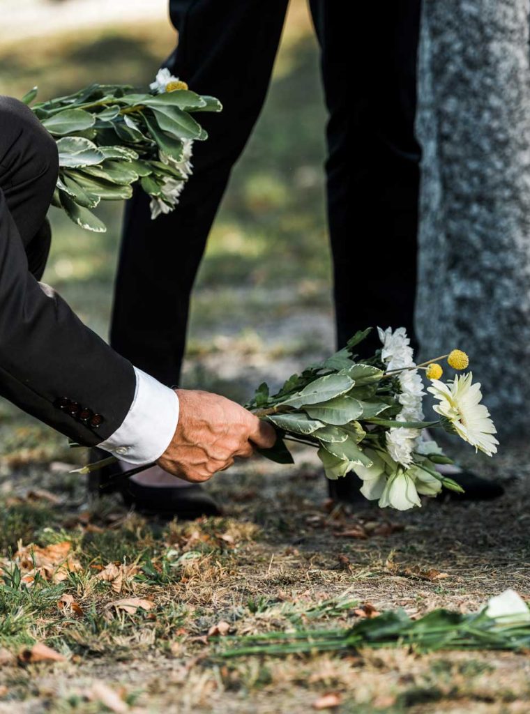 cropped-view-of-senior-man-putting-flowers-near-to-A4V7UQ3.jpg