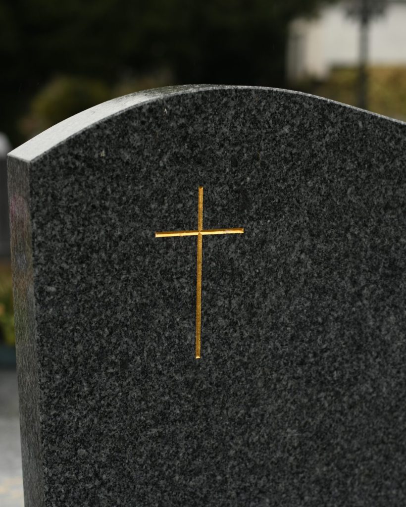 Cross,On,A,Black,Marble,Slab,On,A,Grave,In